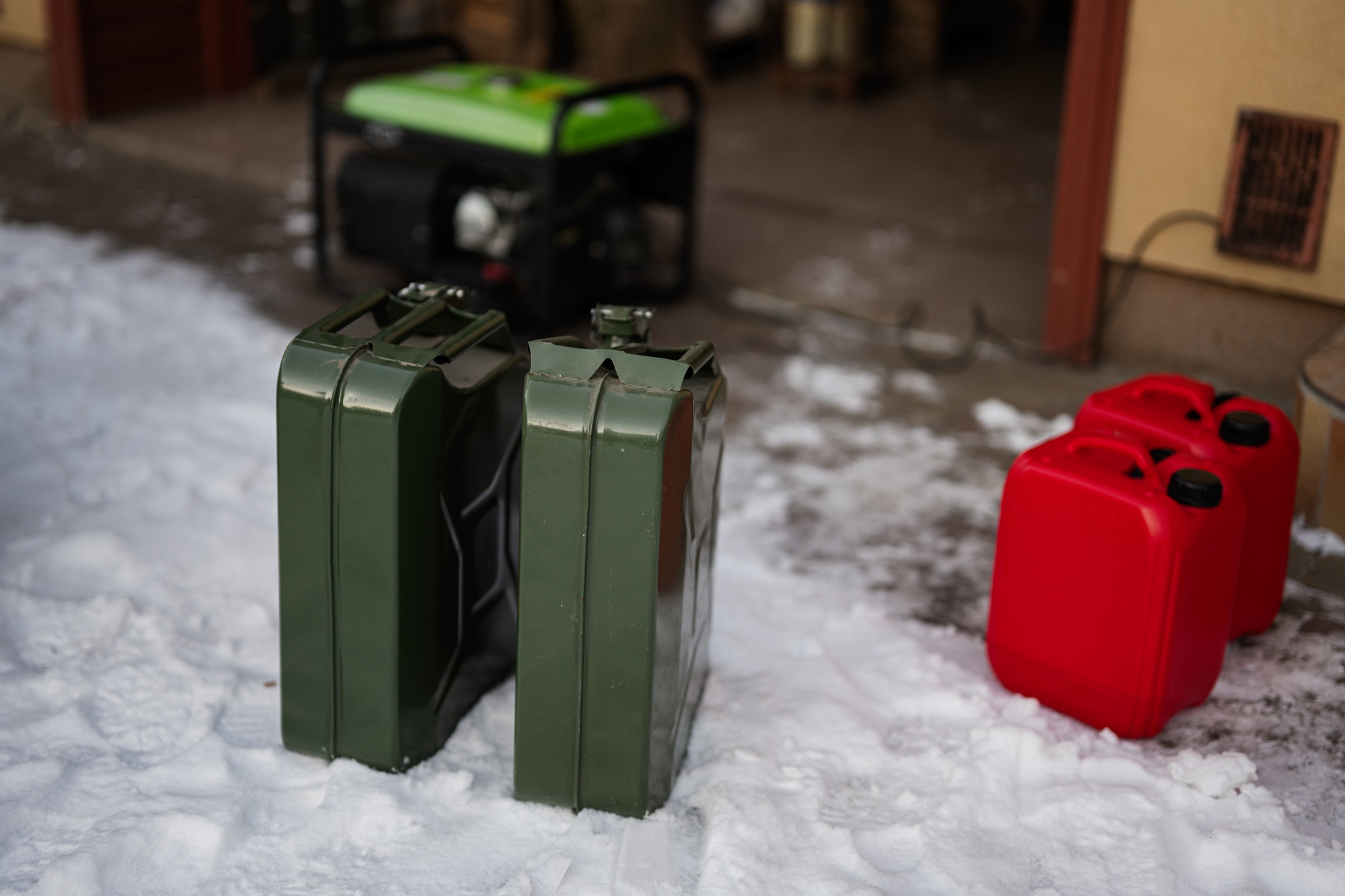 Сanisters with gasoline against portable mobile backup standby generator.