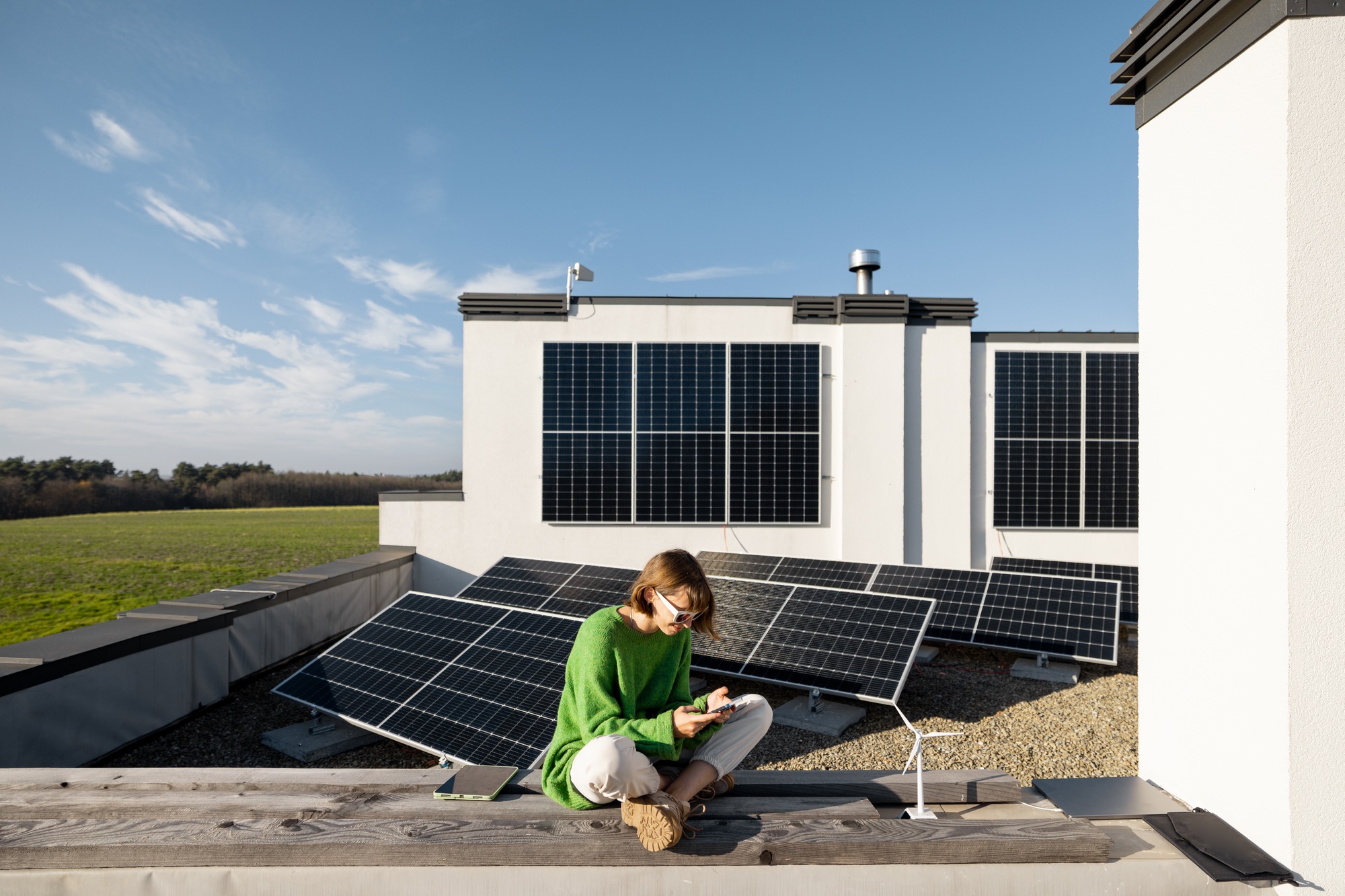 Woman on the roof of her house with a solar plant